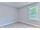 Bright bedroom with a view outside the window, and stylish wood-look flooring at 418 Harrison St, Statesville, NC 28677