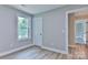 Neutral bedroom with plenty of natural light and modern wood-look flooring at 418 Harrison St, Statesville, NC 28677