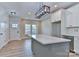Modern kitchen with white cabinets, stainless steel appliances, and a central island with a prep sink at 418 Harrison St, Statesville, NC 28677