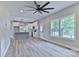 Open-concept living space with a ceiling fan, and view into the kitchen and dining areas at 418 Harrison St, Statesville, NC 28677