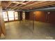 Unfinished basement space with exposed ceiling, brick walls, and ample room for storage or customization at 4476 Nc Hwy 200 Rd, Stanfield, NC 28163