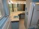 Well-lit bathroom featuring dual sinks, tile flooring, and a shower with a glass door at 4476 Nc Hwy 200 Rd, Stanfield, NC 28163