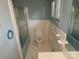 Clean bathroom with white tile, blue trim, and toilet at 4476 Nc Hwy 200 Rd, Stanfield, NC 28163