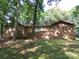 Traditional brick home with mature trees and landscaping around the front yard at 4476 Nc Hwy 200 Rd, Stanfield, NC 28163