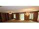 Open living room featuring wood paneling, built-ins, and a chandelier at 4476 Nc Hwy 200 Rd, Stanfield, NC 28163