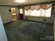 Spacious living room with large windows and floral curtains at 4476 Nc Hwy 200 Rd, Stanfield, NC 28163