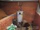 The hot water heater is surrounded by brick and bags of salt for a water softener at 4476 Nc Hwy 200 Rd, Stanfield, NC 28163
