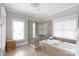 Bright bathroom featuring a glass enclosed shower and a large soaking tub at 4516 Night Heron Ln, Charlotte, NC 28211