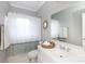 Clean bathroom featuring a white vanity and a shower-tub combo at 4516 Night Heron Ln, Charlotte, NC 28211