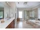 This bathroom features tile flooring, a double sink vanity, tub, and a glass-enclosed shower at 4516 Night Heron Ln, Charlotte, NC 28211