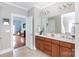 Spacious bathroom with double vanity, tile flooring, and an open doorway to the bedroom at 4516 Night Heron Ln, Charlotte, NC 28211