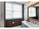 Well-lit bathroom showcasing wood and subway tile, marble countertop, and modern fixtures at 4516 Night Heron Ln, Charlotte, NC 28211