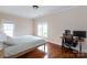 Cozy bedroom with hardwood floors, natural light, and a dedicated workspace at 4516 Night Heron Ln, Charlotte, NC 28211