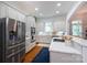 Bright kitchen with stainless appliances, white cabinets, hardwood floors and white countertops at 4516 Night Heron Ln, Charlotte, NC 28211
