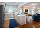 Modern kitchen with stainless steel appliances, white cabinets, island with seating, and hardwood floors at 4516 Night Heron Ln, Charlotte, NC 28211