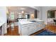 Open floor plan from kitchen to the living room featuring white cabinets and hardwood floors at 4516 Night Heron Ln, Charlotte, NC 28211
