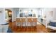 Open kitchen with an island, white cabinets, stainless steel appliances, and hardwood floors at 4516 Night Heron Ln, Charlotte, NC 28211
