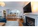 Bright living room with fireplace, TV, wood floors, view of kitchen and living room furniture at 4516 Night Heron Ln, Charlotte, NC 28211