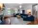 Inviting living room featuring hardwood floors, large sectional sofa and ample natural light at 4516 Night Heron Ln, Charlotte, NC 28211