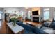 Bright and airy living room featuring hardwood floors, fireplace, and seamless flow into kitchen at 4516 Night Heron Ln, Charlotte, NC 28211