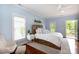 Bright primary bedroom with hardwood floors, a ceiling fan, and access to outdoor balcony at 4516 Night Heron Ln, Charlotte, NC 28211