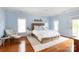 This primary bedroom boasts hardwood floors, a ceiling fan, and ample natural light at 4516 Night Heron Ln, Charlotte, NC 28211