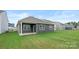 Exterior of home with a back patio, gray siding, and a small grassy area at 4619 Harris Elliot Rd, Lincolnton, NC 28092