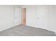 Neutral-toned bedroom featuring gray carpet, white walls, and two doors at 4619 Harris Elliot Rd, Lincolnton, NC 28092