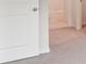 Carpeted bedroom showcasing neutral color scheme, with door and hallway leading to other rooms at 4619 Harris Elliot Rd, Lincolnton, NC 28092