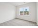A carpeted bedroom with a large window offering natural light at 4619 Harris Elliot Rd, Lincolnton, NC 28092