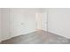 Neutral-toned bedroom featuring gray carpet, white walls, and two doors at 4619 Harris Elliot Rd, Lincolnton, NC 28092