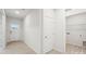 Clean and bright entryway with wood-look flooring and doors leading to a laundry room at 4619 Harris Elliot Rd, Lincolnton, NC 28092