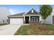 Charming single-story home featuring a stone and gray shingle facade, well-manicured lawn, and a two-car garage at 4619 Harris Elliot Rd, Lincolnton, NC 28092