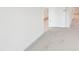Hallway with carpet and doorway leading to kitchen with bright lighting at 4619 Harris Elliot Rd, Lincolnton, NC 28092