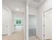 Bright hallway with neutral walls, hardwood floors, and doors leading to various rooms at 4619 Harris Elliot Rd, Lincolnton, NC 28092