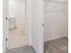 Hallway leads to bathroom and closet with wire shelving; neutral walls and flooring throughout at 4619 Harris Elliot Rd, Lincolnton, NC 28092