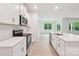Bright kitchen with white countertops, stainless steel appliances, and views to an airy, sunlit living space at 4619 Harris Elliot Rd, Lincolnton, NC 28092