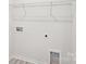Utility area featuring washer and dryer hookups, wire shelving and vinyl flooring, creating convenience at 4619 Harris Elliot Rd, Lincolnton, NC 28092