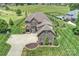 Aerial view of a home with a long driveway, lush landscaping, a pool, and a manicured lawn at 4941 Campobello Dr, Monroe, NC 28110