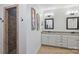 Bathroom with a tiled shower, framed mirrors, granite countertops, and a dual sink vanity at 4941 Campobello Dr, Monroe, NC 28110