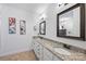 Well-lit bathroom featuring double sinks, granite countertops, framed mirrors, and modern fixtures at 4941 Campobello Dr, Monroe, NC 28110