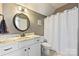 Bright bathroom featuring a white vanity with marble countertop and a shower with white curtain at 4941 Campobello Dr, Monroe, NC 28110
