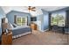 Comfortable bedroom with a ceiling fan, carpet flooring, and a desk area with ample natural light at 4941 Campobello Dr, Monroe, NC 28110