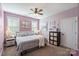 Cozy bedroom with soft lavender walls, carpet flooring, and natural light from the two large windows at 4941 Campobello Dr, Monroe, NC 28110