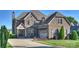Lovely brick home featuring an attached two-car garage, manicured lawn, and spacious driveway at 4941 Campobello Dr, Monroe, NC 28110