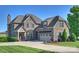 Beautiful brick home featuring a well manicured lawn, mature landscaping and a three car garage at 4941 Campobello Dr, Monroe, NC 28110