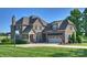 Traditional brick home featuring an attached two-car garage, manicured lawn and driveway at 4941 Campobello Dr, Monroe, NC 28110