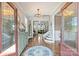 Warm and inviting foyer with hardwood floors, a chandelier, and views into the living room at 4941 Campobello Dr, Monroe, NC 28110