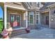 Inviting front porch with brick steps, columns, decorative door, and lush landscaping at 4941 Campobello Dr, Monroe, NC 28110