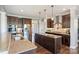 Updated kitchen featuring a center island, granite countertops, stainless steel appliances, and dark wood cabinetry at 4941 Campobello Dr, Monroe, NC 28110